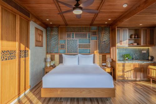 a bedroom with a large white bed in a room at Bonny Boutique Hotel Da Nang in Da Nang