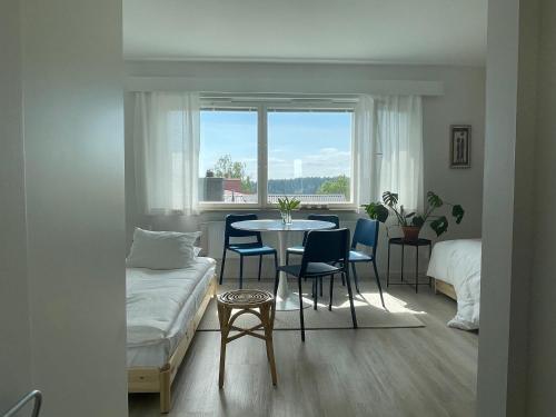 a room with a table and chairs and a window at Studio korttelin päässä Olavinlinnasta in Savonlinna