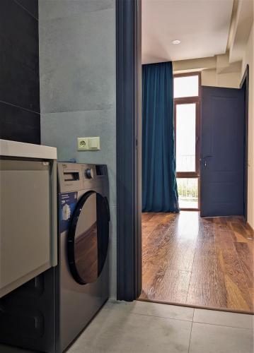 a kitchen with a washing machine and a window at Milky Way in Stepantsminda