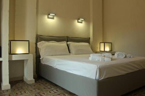 A bed or beds in a room at Masseria Fulcignano