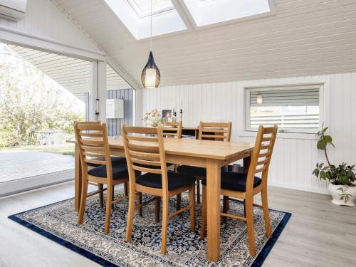a dining room with a wooden table and chairs at Cozy Retreat by Koge Bay - By Traum Ferienwohnungen in Strøby