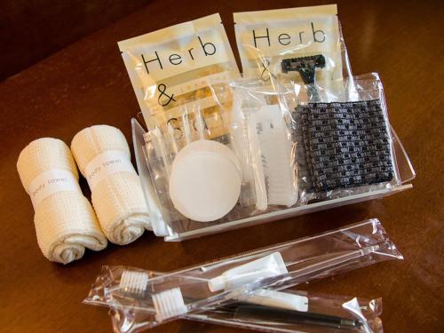 a table with a box of herds and cosmetics at Hotel Den Haag Huis Ten Bosch in Sasebo