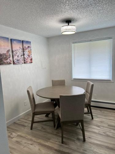 a dining room with a table and chairs and a window at Beautiful downtown Anchorage 4 in Anchorage