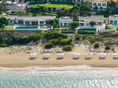 a group of cars parked on the beach at Mandola Rosa at Riviera Olympia, A Grecotel Resort to Live in Loutra Killinis