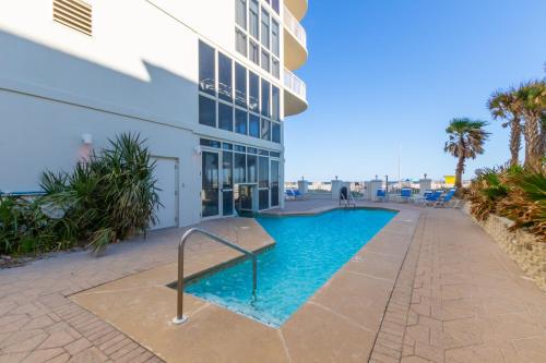 a swimming pool in front of a building at Luxury Penthouse Style Condo Oceania 2 in Gulf Shores