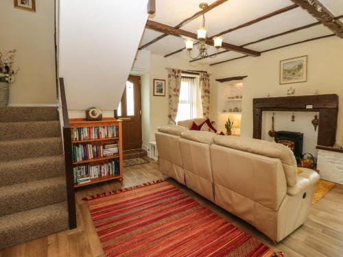 a living room with a couch and a fireplace at River Cottage in Penrith