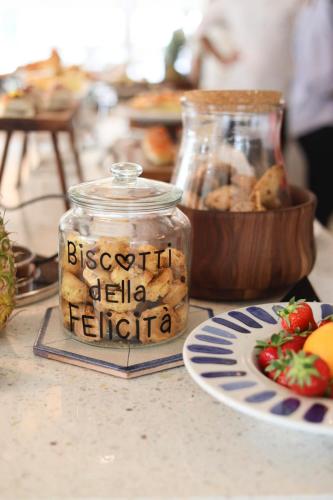 a jar filled with food next to a plate of food at Hotel Albatros in Rimini