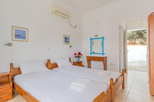 a bedroom with two beds and a window at Sifnos studio 4 in Sifnos