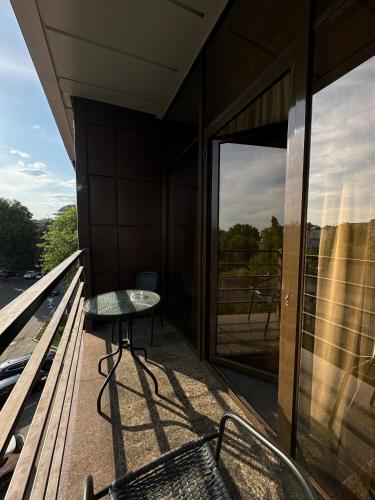 a glass table on the balcony of a building at Hotel Atmosphere in Poltava