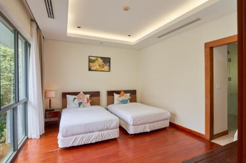 Ένα ή περισσότερα κρεβάτια σε δωμάτιο στο Ocean Sunny Villas Da Nang