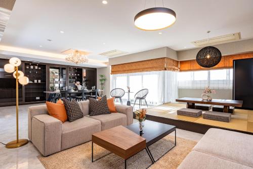 a living room with a couch and a table at JAPAVISTA Xenith Premium in Osaka