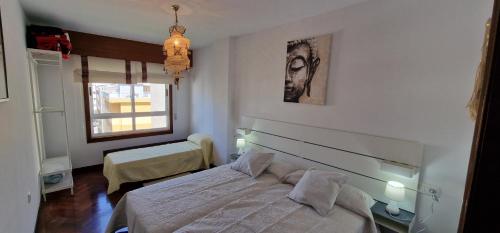 a bedroom with a bed and a window at El Mirador de Covas - 2 Hab - Garaje in Covas