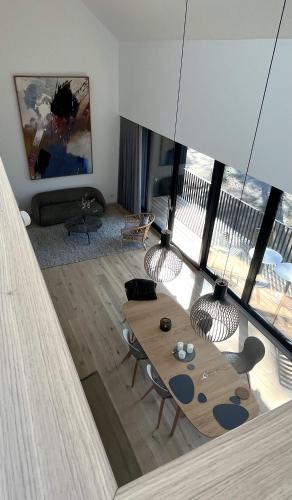 a living room with a wooden table and chairs at Luxus-Oase mit Seeblick in Bad Saarow