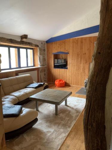 un salon avec un canapé et une table dans l'établissement Gîtes Domaine De Silhac Ardèche, à Silhac