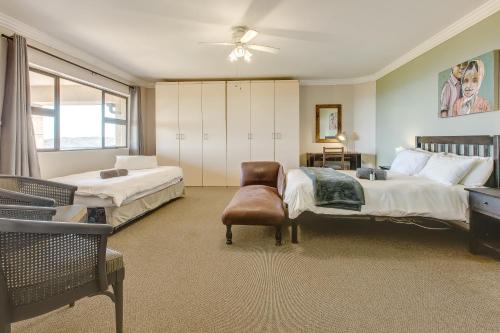 ein großes Schlafzimmer mit 2 Betten und einem Stuhl in der Unterkunft Garden Route Ilita Lodge in Groot Brak Rivier