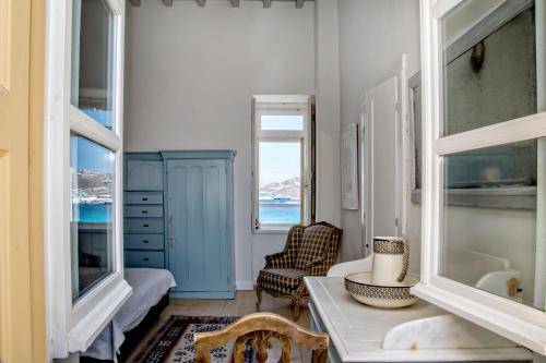 a living room with a blue cabinet and a table at CAMBANIS MΑΝSION in Mýkonos City