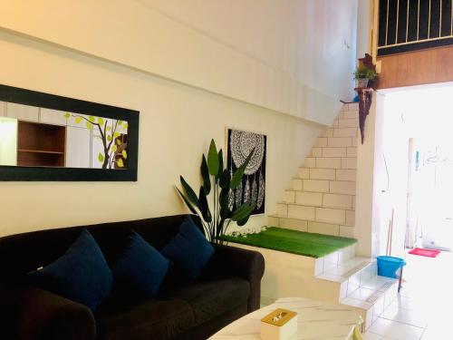 a living room with a couch and a staircase at Duplex Axis Condo @Ampang nearby KLCC. in Ampang