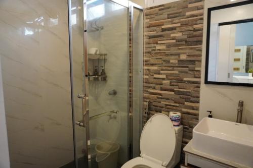 a bathroom with a shower and a toilet and a sink at Costa Liz Island Resort in Pooc