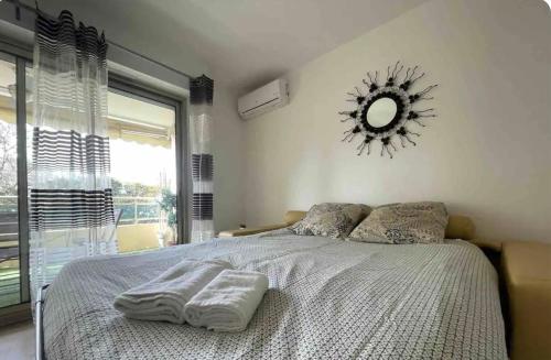 une chambre avec un lit avec un miroir au mur dans l'établissement Studio terrasse-Croisette, Palais Festivals 10 min, à Cannes