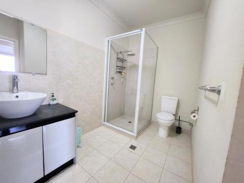 a bathroom with a shower and a sink and a toilet at Sandpiper Escape in Jurien Bay