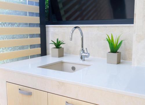 a kitchen sink with two potted plants on it at Luxury Sea Villa - Kabalan 1 in Burgas City