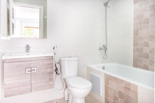 a bathroom with a toilet and a sink and a tub at Appartements Calmes et Spacieux in Tetouan