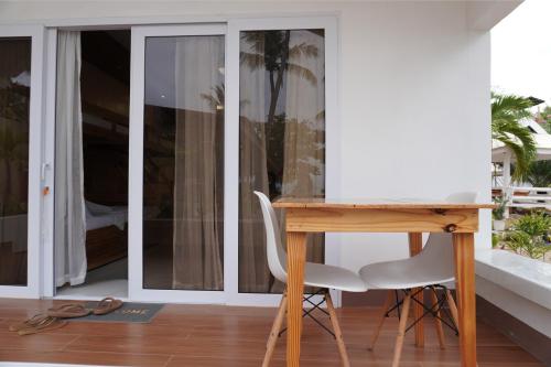a desk with a chair next to a window at Costa Liz Island Resort in Pooc