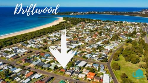 an aerial view of a suburb with a white arrow pointing to the city at Driftwood at Blacksmiths in Blacksmiths