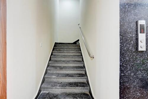 a staircase in an empty room with a stair railing at FabHotel Sky - Nr Sapphire 83 Mall, Manesar in Gurgaon