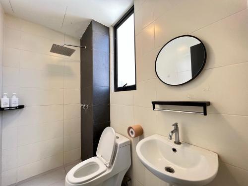 a bathroom with a sink and a toilet and a mirror at RiverView 8PAX 3BR in KBtown Wi-Fi, B-12-2 in Kota Bharu