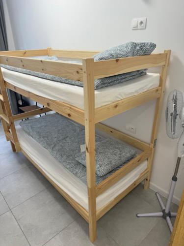 a wooden bunk bed with four tiers at Gray Hostel Katowice - Parking in Katowice