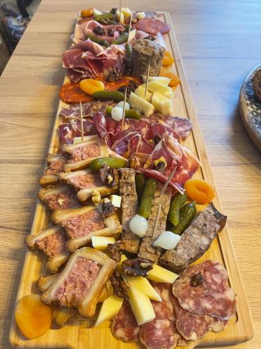 a tray of different types of food on a table at Gîte le grand chacel in Sourcieux-les-Mines