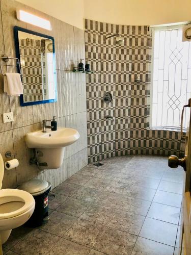 a bathroom with a sink and a toilet at AruBhi Cottage in Dehradun