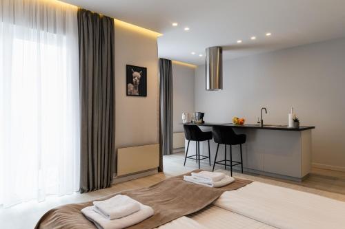 a bedroom with a bed and a table with chairs at ММ GROUP APARTMENT in Uzhhorod