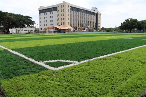 a soccer field with a building in the background at RCMRD EXECUTIVE SUITEs in Nairobi