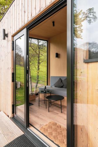 a glass extension to a house with a living room at cozy Black Forest Tiny House close to lake in Schluchsee