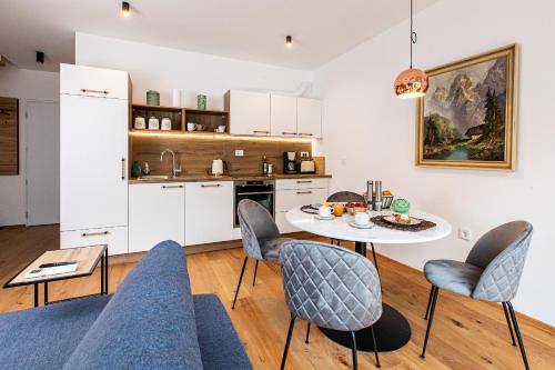 a kitchen and living room with a table and chairs at Apartma 21 - Ajda in Bovec