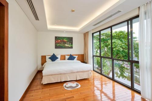 Ένα ή περισσότερα κρεβάτια σε δωμάτιο στο Ocean Sunny Villas Da Nang