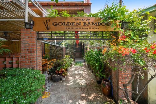 a garden yard with a sign that reads golden rangoon at Hoi An Golden Bamboo An Bang Beach Villa & Spa in Hoi An