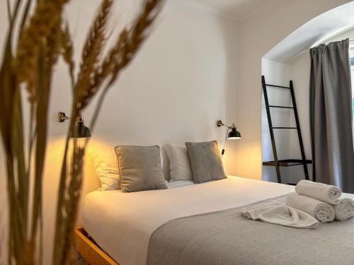 a bedroom with a bed with towels on it at 262 Baixa Guesthouse in Lisbon