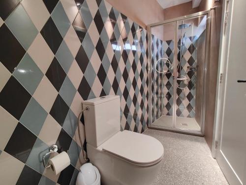 a bathroom with a toilet and a shower at Sbejha Guest House in Naxxar