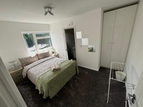 a bedroom with a bed with a towel on it at Cosy rooms in Cambridge in Cambridge