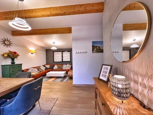 a living room with a couch and a mirror at Chy Mena. South facing lodge with hot tub & views. in St. Agnes 