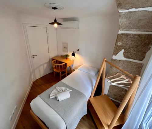 a small room with a bed and a table at 262 Baixa Guesthouse in Lisbon