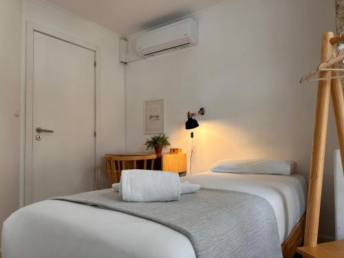a small bedroom with two beds and a window at 262 Baixa Guesthouse in Lisbon