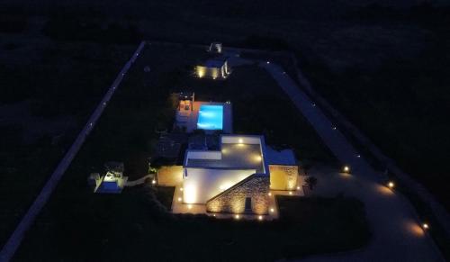 an aerial view of a house at night with lights at Leukos, dimora di charme in Salve