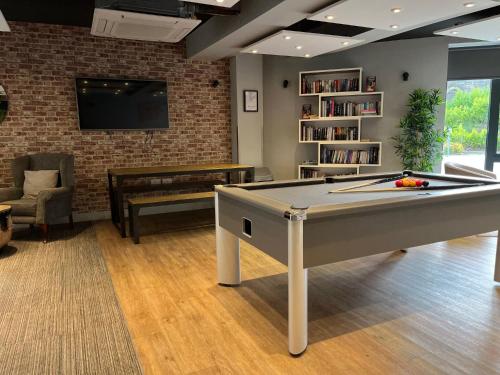 a living room with a pool table and a tv at Chapel Heights in Durham in Durham