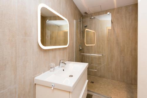 une salle de bain avec un lavabo blanc et une douche dans l'établissement Rosa Bonheur by Cocoonr, à Toulouse