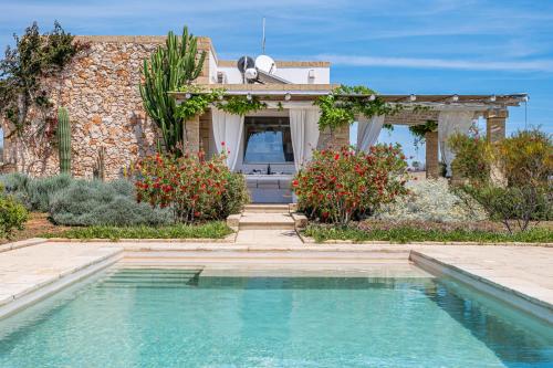 a house with a swimming pool in front of a house at Leukos, dimora di charme in Salve