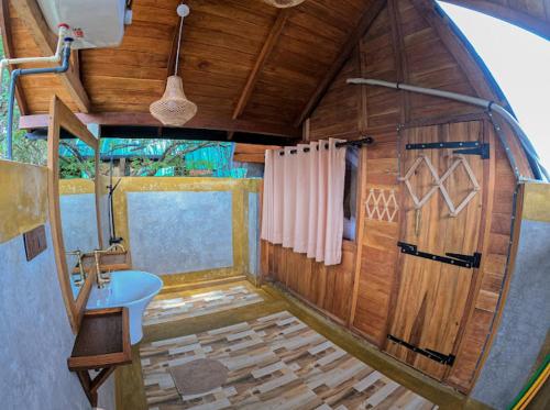 a bathroom with a toilet and a sink in a room at Sundown Lake Hotel & Spa in Habarana